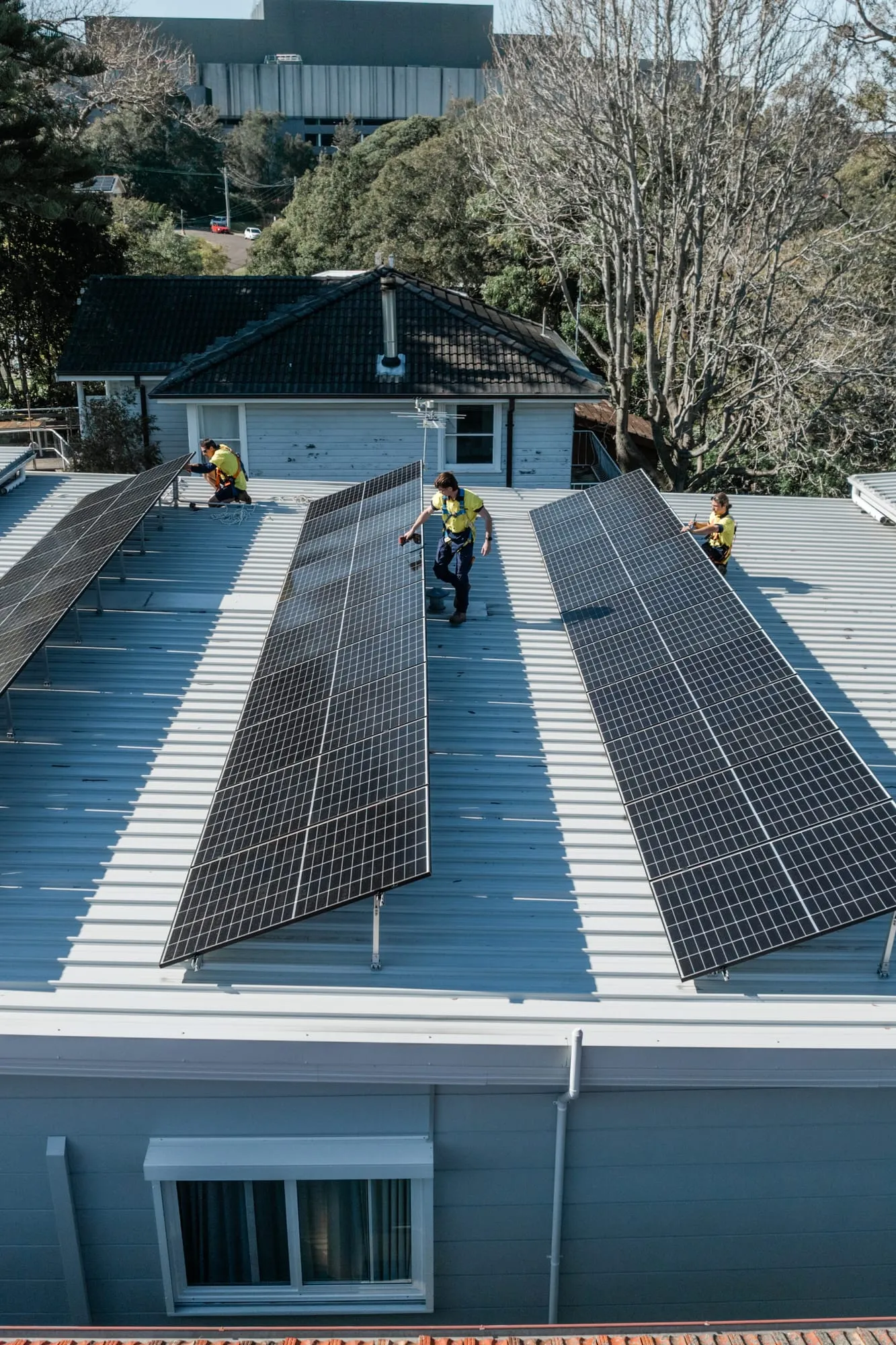 Aerial view of a large rooftop solar array installed across a Newcastle home