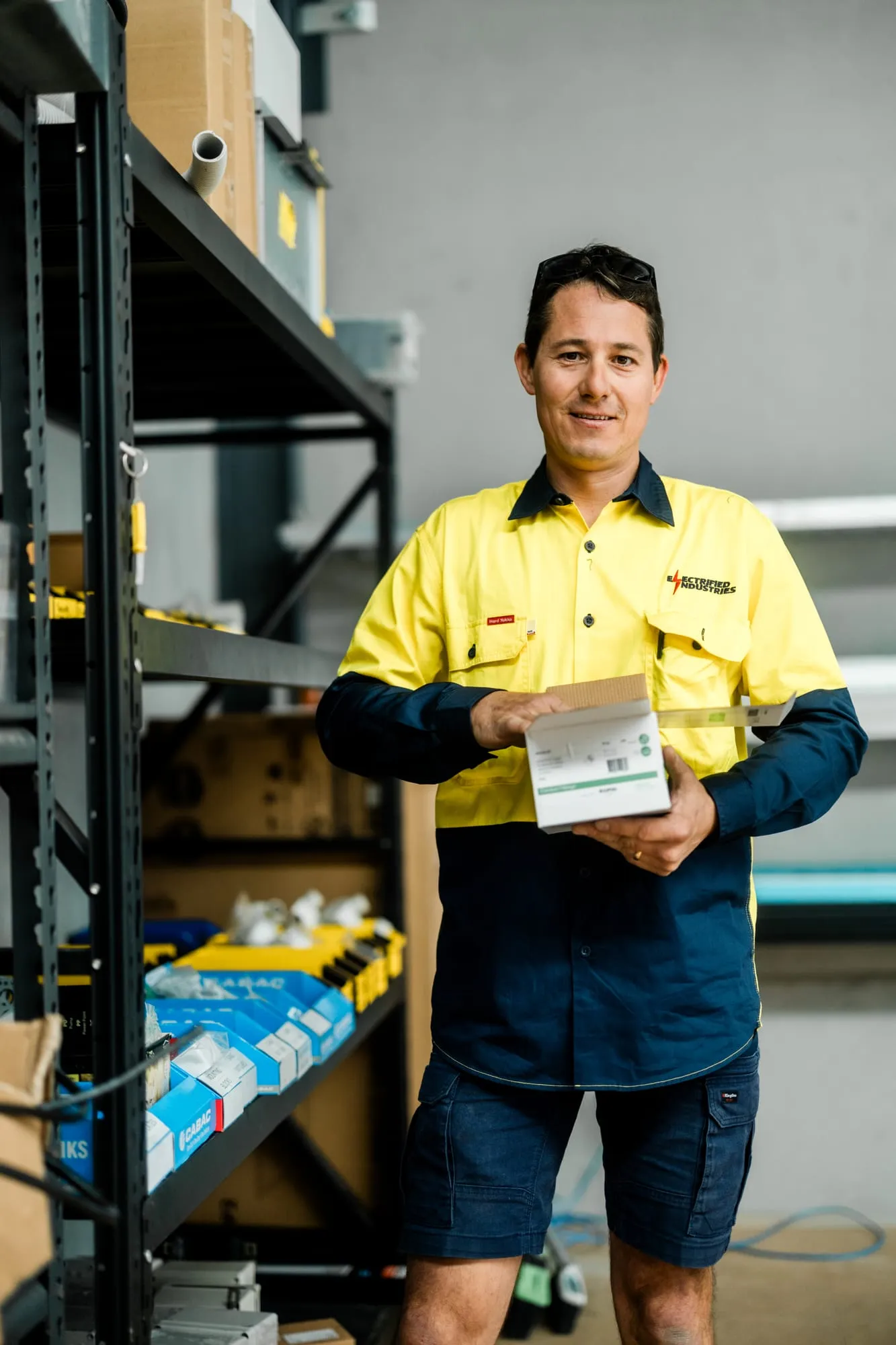 An Electrified Industries team member with replacement solar parts